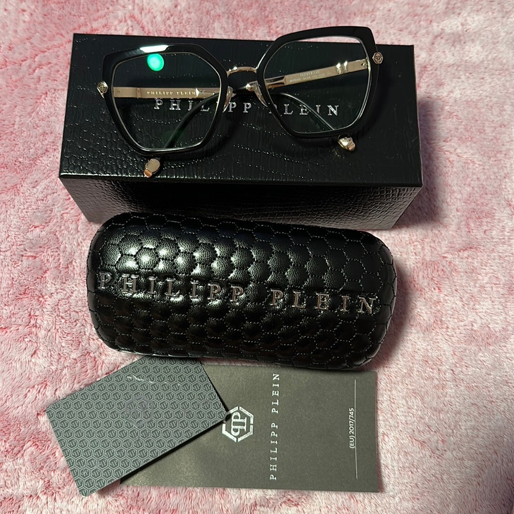 Philipp Plein Eyeglass VPP036s Black frame w/gold crystal skull temple accents.